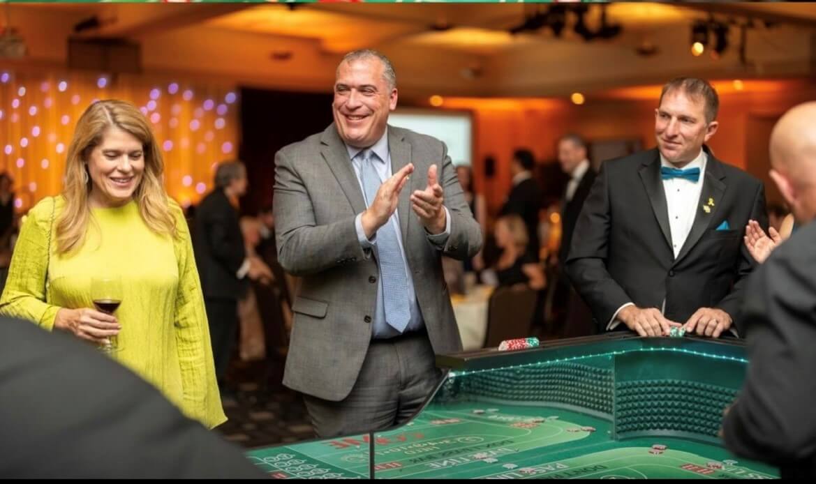Guest at a craps table during a casino party fundraiser