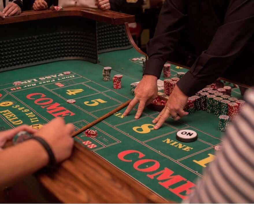 Dealer teaching players how to play craps in kohler